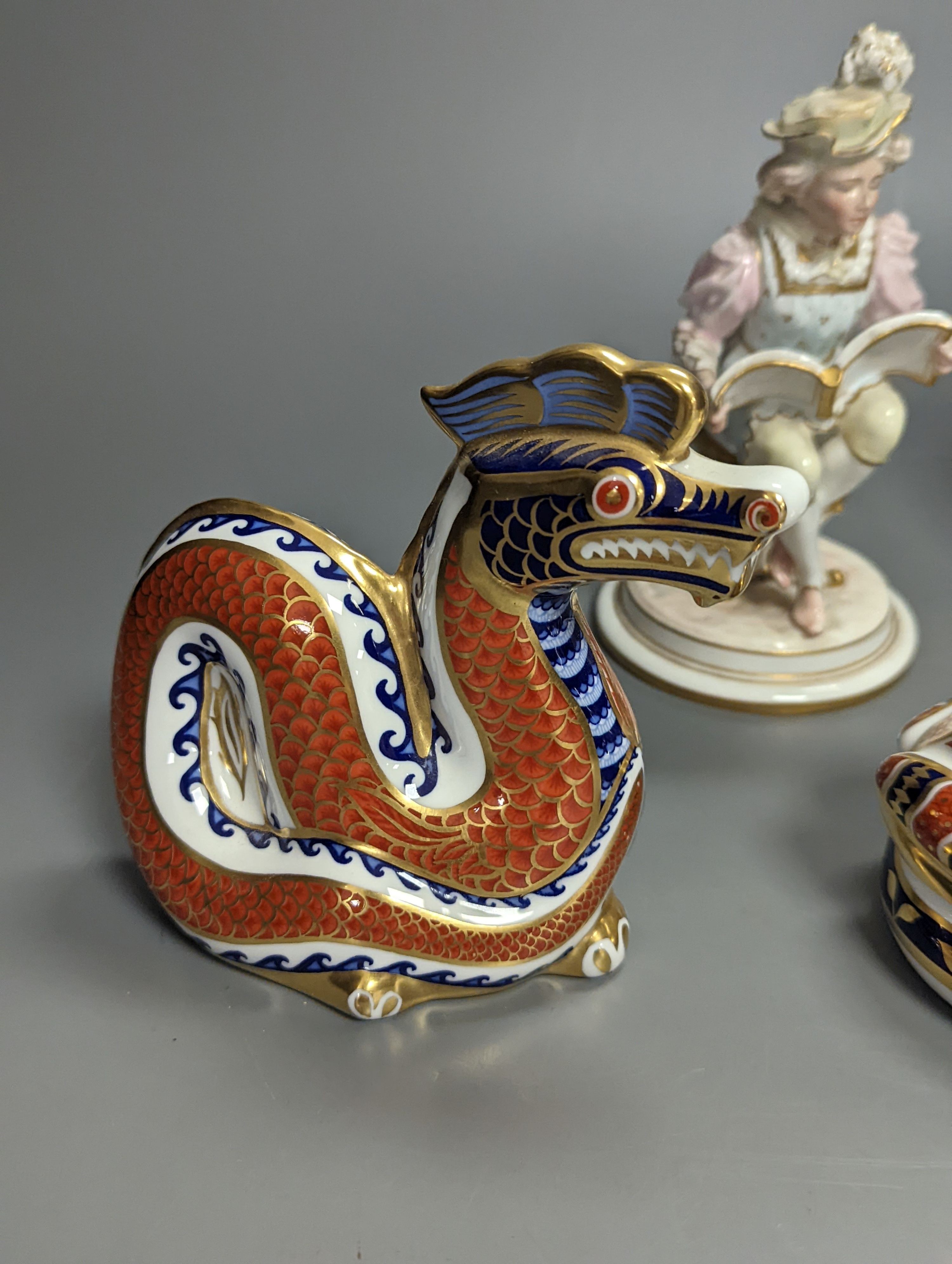 A pair of Royal Crown Derby figures of musicians, c.1905, 15cm, two similar animal paperweights and a Latticino glass slipper, tallest being the dragon 11cm